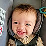 baby, car_seat, smile, child, infant, face, safety_harness, onesie, cute, happy, straps, seat_belt, adorable, young_child, head, eyes, mouth, clothing, indoor, portrait