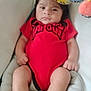 baby, infant, red_clothing, sombrero, hat, cushion, foot, hand, face, person, indoor, toy, soft_toy, comfort, child, closeup, expression, skin, legs, headwear