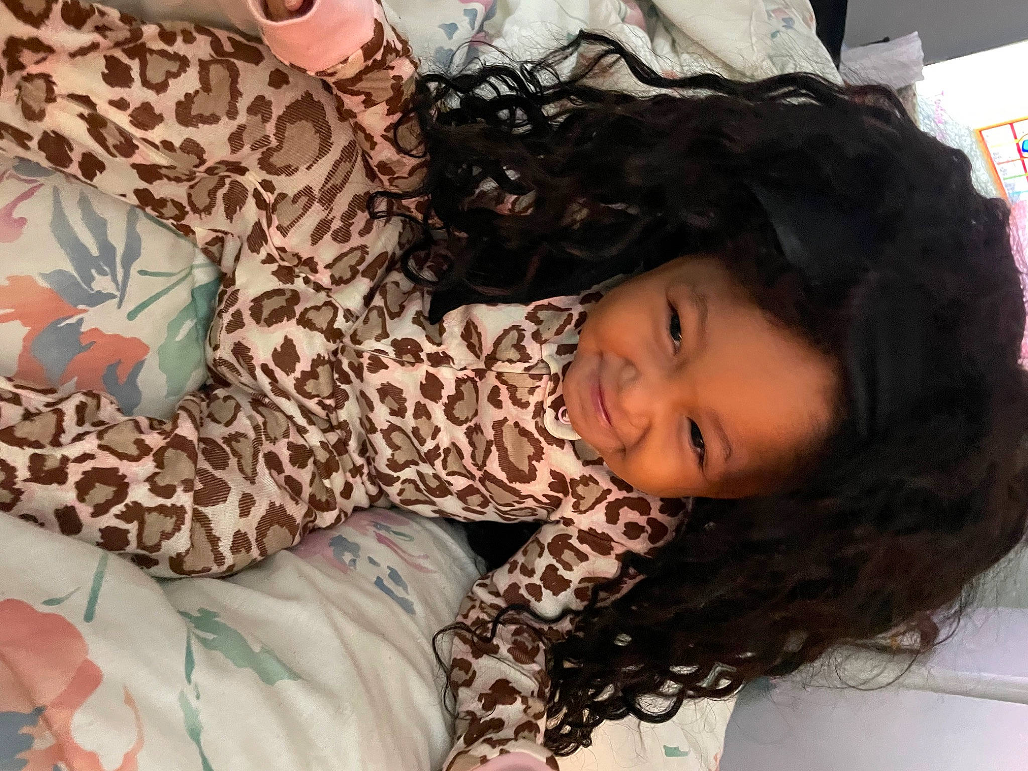 Jaliyah is registered to the contest to win money with this photo: brown_hair, child, comfort, couch, dress, eyelash, fashion_design, happy, human, joy, linens, long_hair, mammal, pattern, people, person, room, sitting, skin, smile