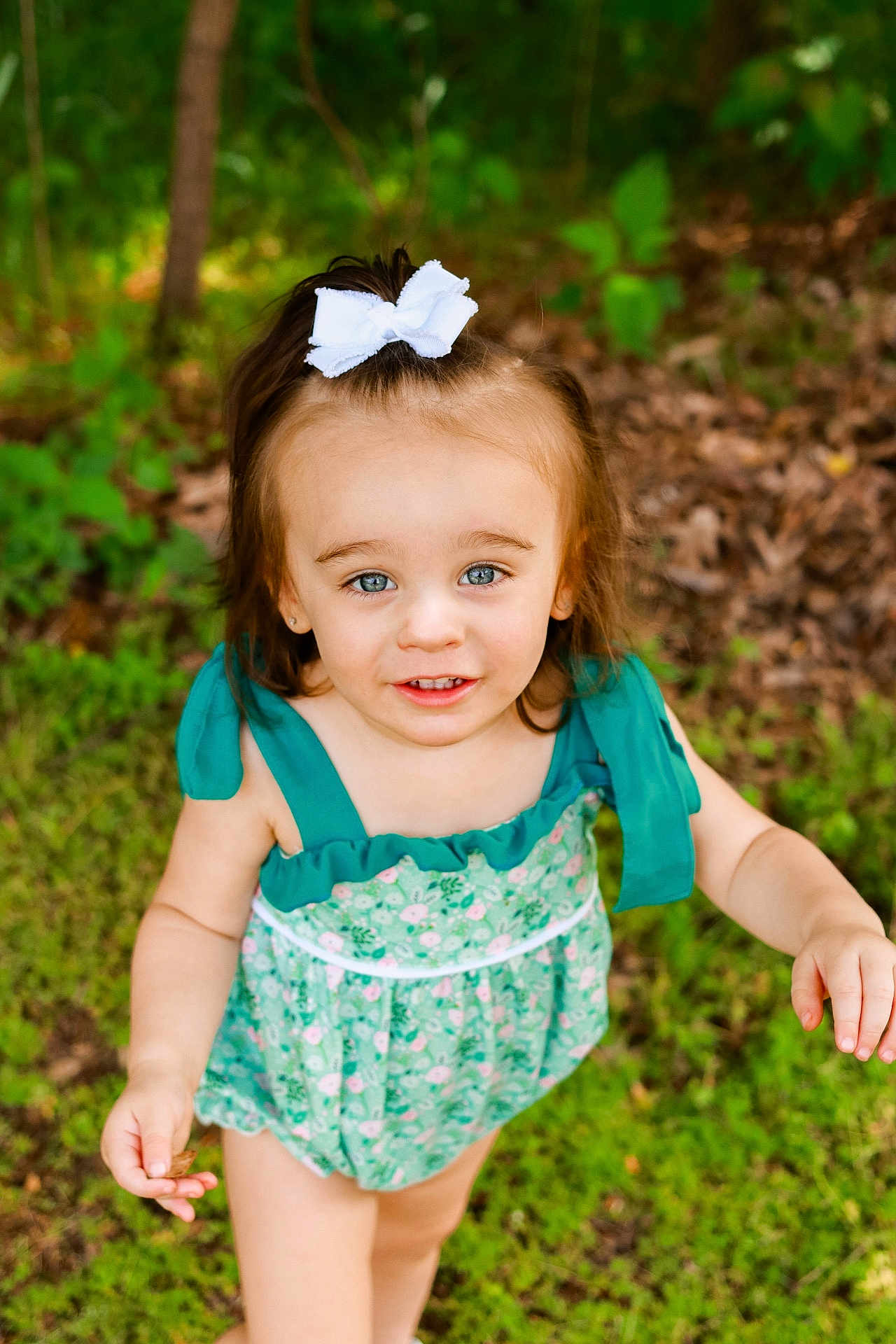 Lilly joined the competition — help win amazing prizes! toddler, child, girl, outdoor, grass, greenery, forest, romper, bow, smile, face, blue_eyes, hair_accessory, summer, nature, portrait, cute, happy, playful, person