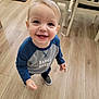 Spencer is registered to the contest to win money with this photo: toddler, child, smiling, indoor, wooden_floor, shirt, big_bro, blue_sleeves, happy, standing, person, furniture, chair, pet_crate, flooring, casual_clothing, cute, young_child, portrait, home