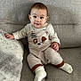 Raphaël participe au concours pour gagner de l'argent avec cette photo : baby, child, couch, sofa, infant, smiling, face, overalls, socks, pillow, indoor, cute, seated, person, apparel, fabric, home, comfort, portrait, young