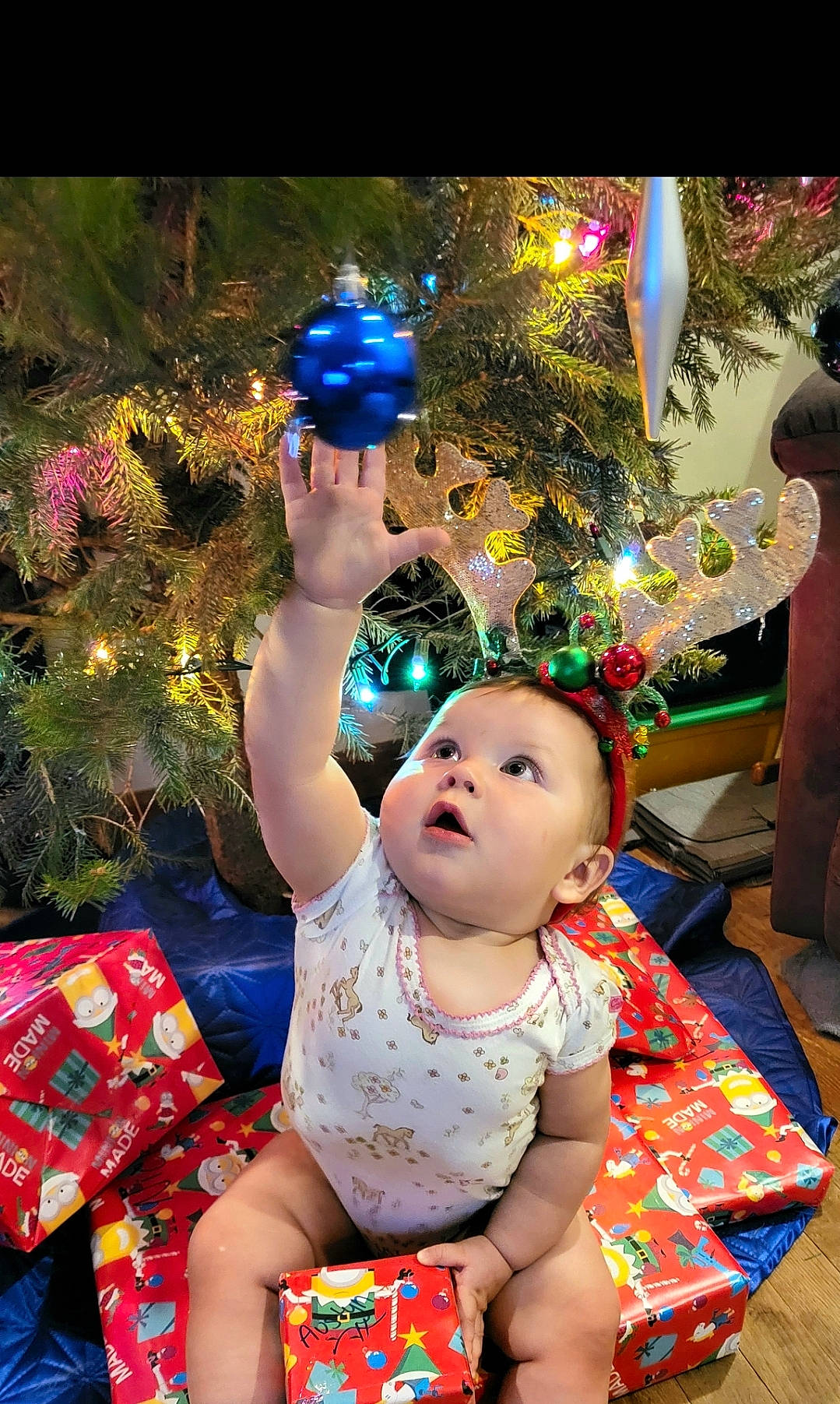 Austyn joined the competition — help win amazing prizes! baby, baby_toddler_clothing, christmas, christmas_decoration, christmas_eve, christmas_ornament, christmas_tree, event, fun, grass, happy, holiday, holiday_ornament, leisure, lighting, ornament, party, person, plant, surprise