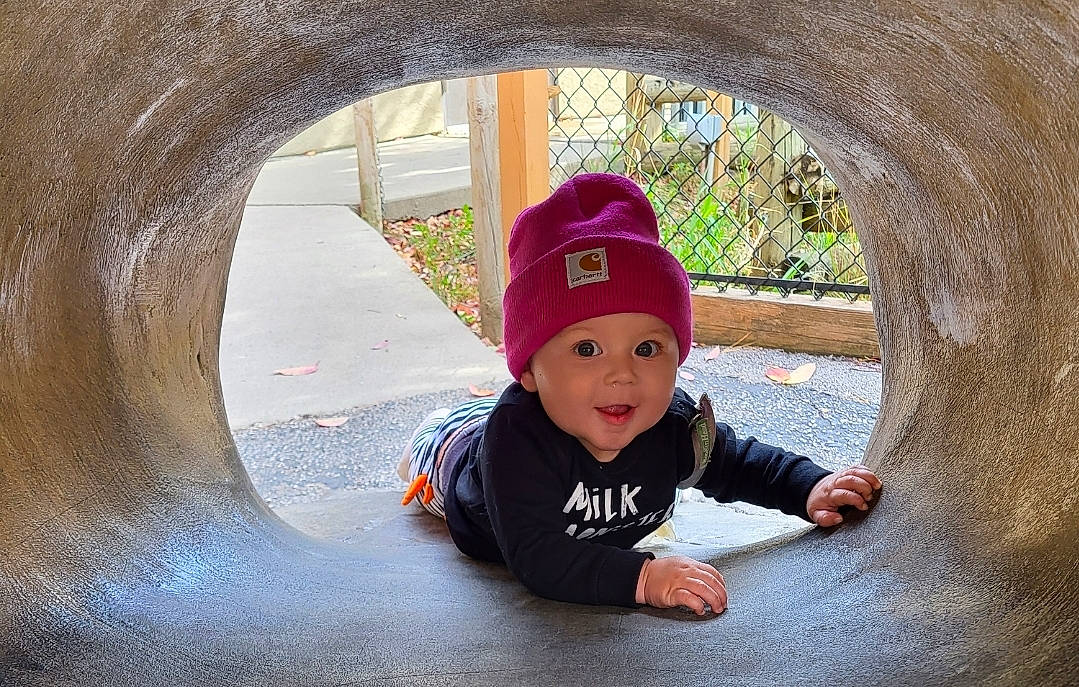 Austyn joined the competition — help win amazing prizes! art, baby, baby_toddler_clothing, cap, concrete, fashion_accessory, flooring, fun, grass, hat, headwear, leisure, pattern, person, sitting, sleeve, smile, t_shirt, tints_and_shades, toddler