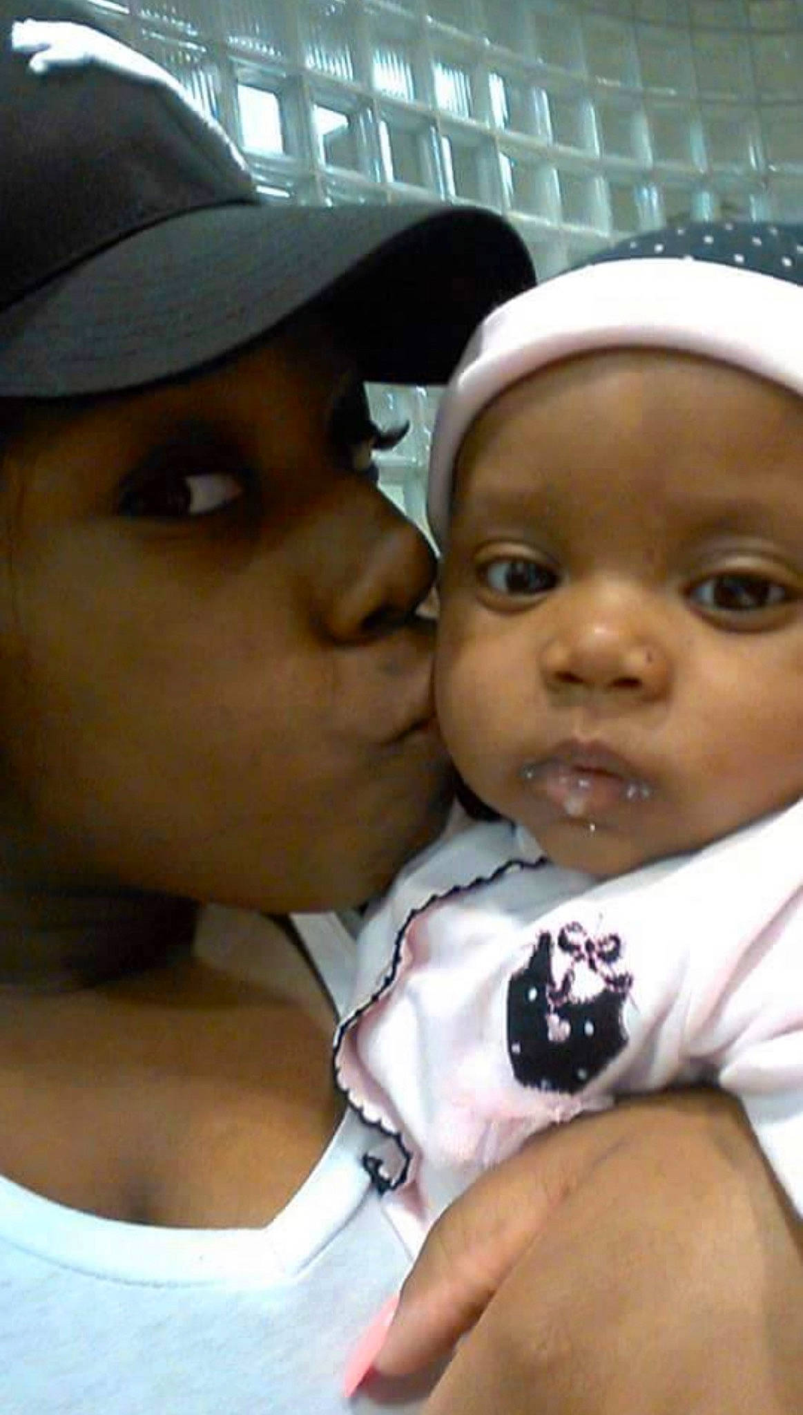 Desire White is registered to the contest to win money with this photo: baby, baby_toddler_clothing, baseball_cap, cap, cheek, child, event, eye, eyelash, fun, gesture, happy, kiss, lip, nose, person, sharing, smile, thumb, toddler