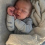 baby, sleeping, blanket, soft_texture, peaceful, infant, indoors, cute, cozy, child, hands, face, wearing_clothes, resting, warm, portrait, newborn, lying_down, comfort, nap