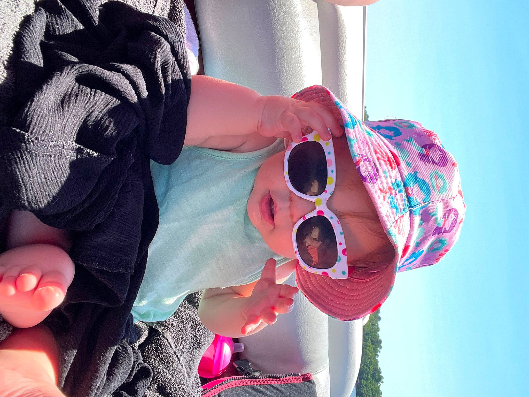 Mckinley is registered to the contest to win money with this photo: blue, cool, eyewear, finger, gesture, glasses, goggles, hand, happy, hat, headgear, headwear, person, pink, plant, purple, red, sky, sun_hat, sunglasses