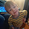 Beckett joined the competition — help win amazing prizes! toddler, child, smiling, striped_sweater, indoor, toy_car, wooden_floor, couch, curtain, lamp, happy, person, face, playful, clothing, hair, young_child, furniture, living_room, casual