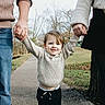 Beckett joined the competition — help win amazing prizes! toddler, child, adult, holding_hands, outdoor, pathway, trees, fall, sweater, jeans, smile, happy, family, park, nature, person, casual_clothing, grass, seasonal, daytime
