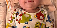 Otto joined the competition — help win amazing prizes! baby, infant, onesie, colorful_clothing, car_print, blanket, patterned_blanket, cute, smiling, lying_down, child, young_child, face, hands, blue_eyes, indoor, soft_lighting, bed, comfort, happy