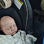 baby, infant, newborn, sleeping, car_seat, blanket, cozy, car_interior, head, face, closed_eyes, peaceful, fabric, warning_label, stitching, plush, portrait, transportation, child_safety, seat