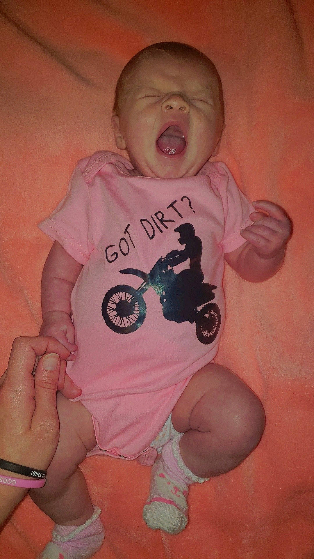 Trystin is registered to the contest to win money with this photo: arm, baby, baby_toddler_clothing, cheek, finger, font, gesture, hand, happy, mouth, nail, neck, person, pink, skin, sleeve, t_shirt, thumb, toddler, toy