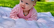 Kennzie joined the competition — help win amazing prizes! baby, child, infant, bow, headband, pink_clothing, blanket, grass, outdoor, nature, greenery, smile, cute, portrait, young_child, playful, sunlight, park, head, face