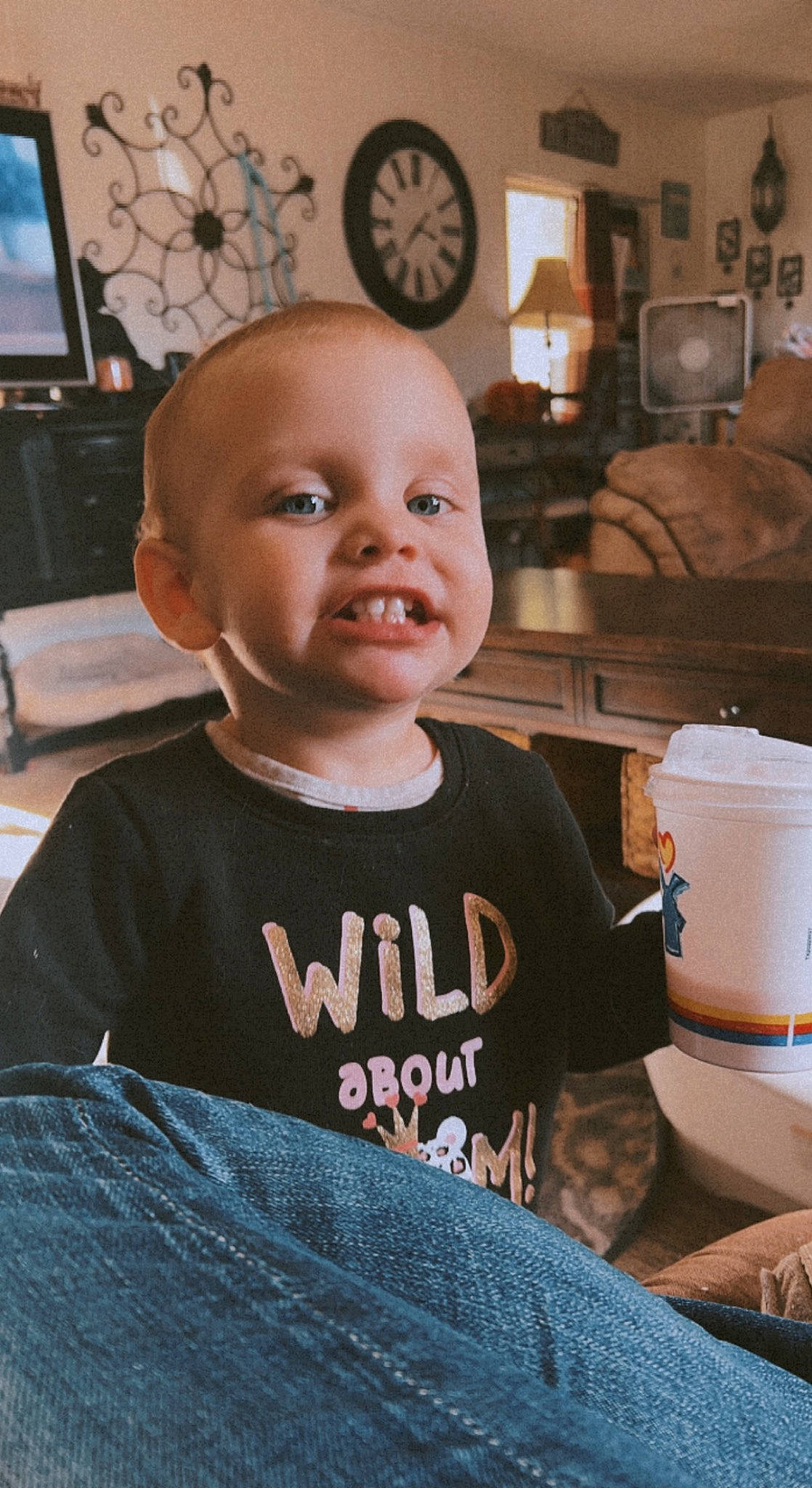 Oaklee is registered to the contest to win money with this photo: baby, baby_toddler_clothing, cheek, child, clock, flooring, fun, hairstyle, happy, living_room, person, picture_frame, room, sitting, sleeve, smile, standing, t_shirt, toddler, vacation