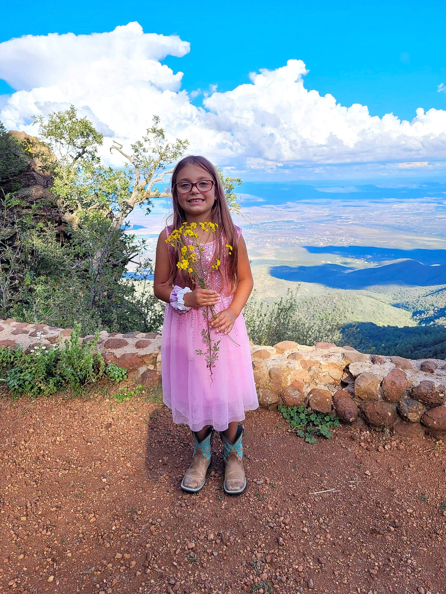 Aleena joined the competition — help win amazing prizes! beauty, clothing, cloud, cumulus, dress, electric_blue, flower, grass, grassland, happy, joy, landscape, leisure, mountain, people_in_nature, person, plant, sky, smile, toddler