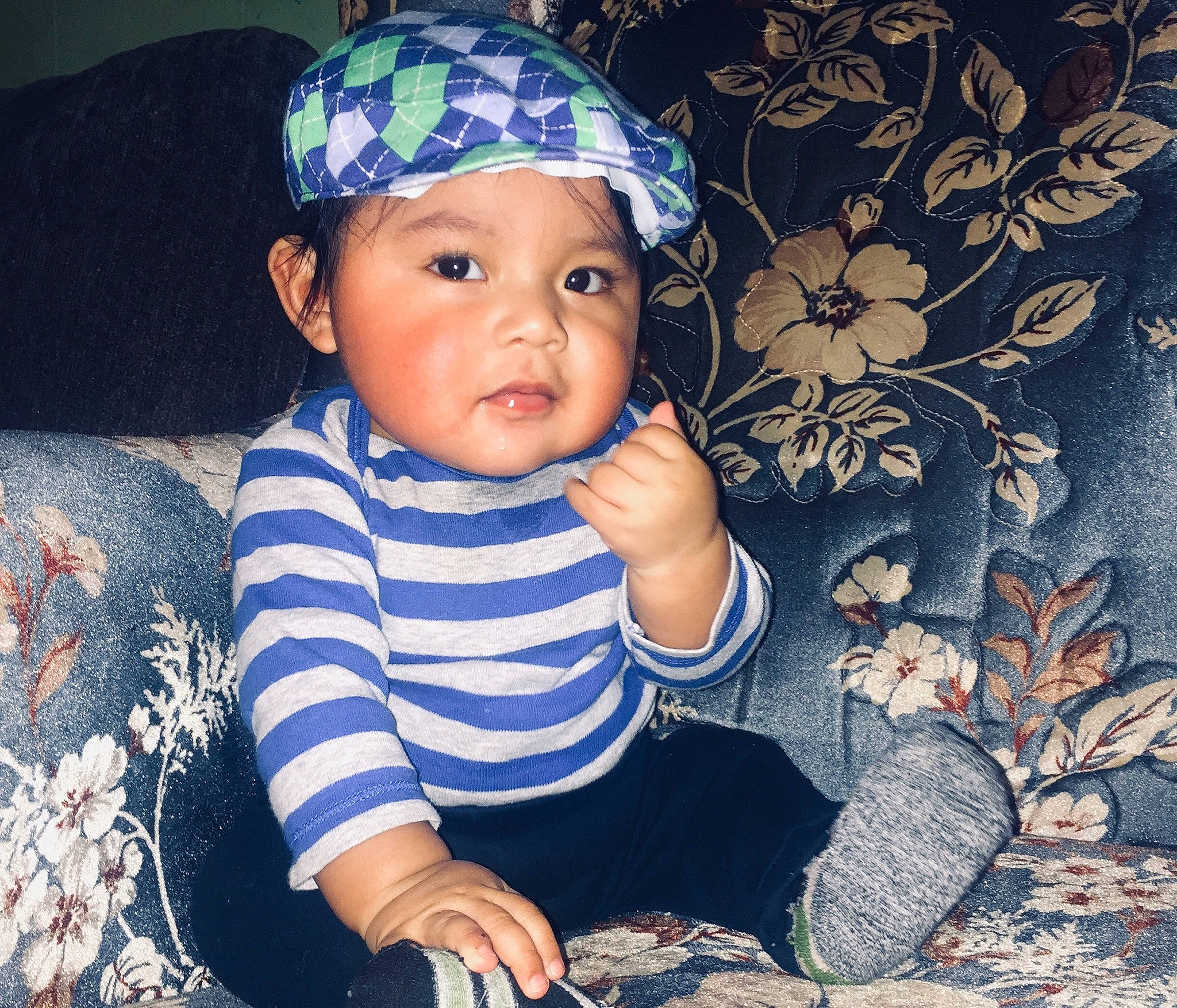 Fabian is registered to the contest to win money with this photo: baby, beanie, cap, cheek, child, cool, eye, face, fashion_accessory, happy, hat, head, headgear, headwear, pattern, person, play, portrait, sitting, smile