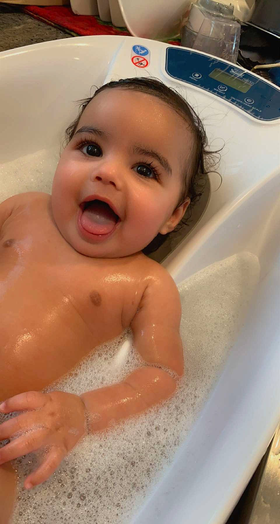 Liam is registered to the contest to win money with this photo: baby_bathing, bathtub, cheek, chin, eye, eyebrow, face, facial_expression, fluid, forehead, hair, head, human_body, jaw, lip, mouth, nose, person, product, skin