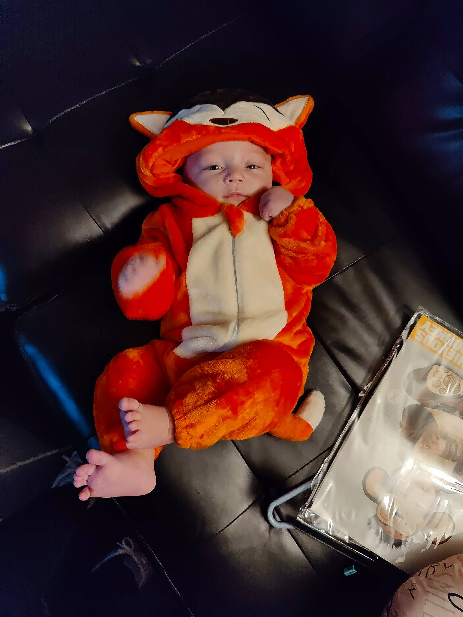 Alec is registered to the contest to win money with this photo: auto_part, automotive_design, baby_products, car_seat, child, comfort, couch, fun, headwear, human_leg, lap, luxury_vehicle, motor_vehicle, orange, peach, person, room, sitting, stuffed_toy, toy