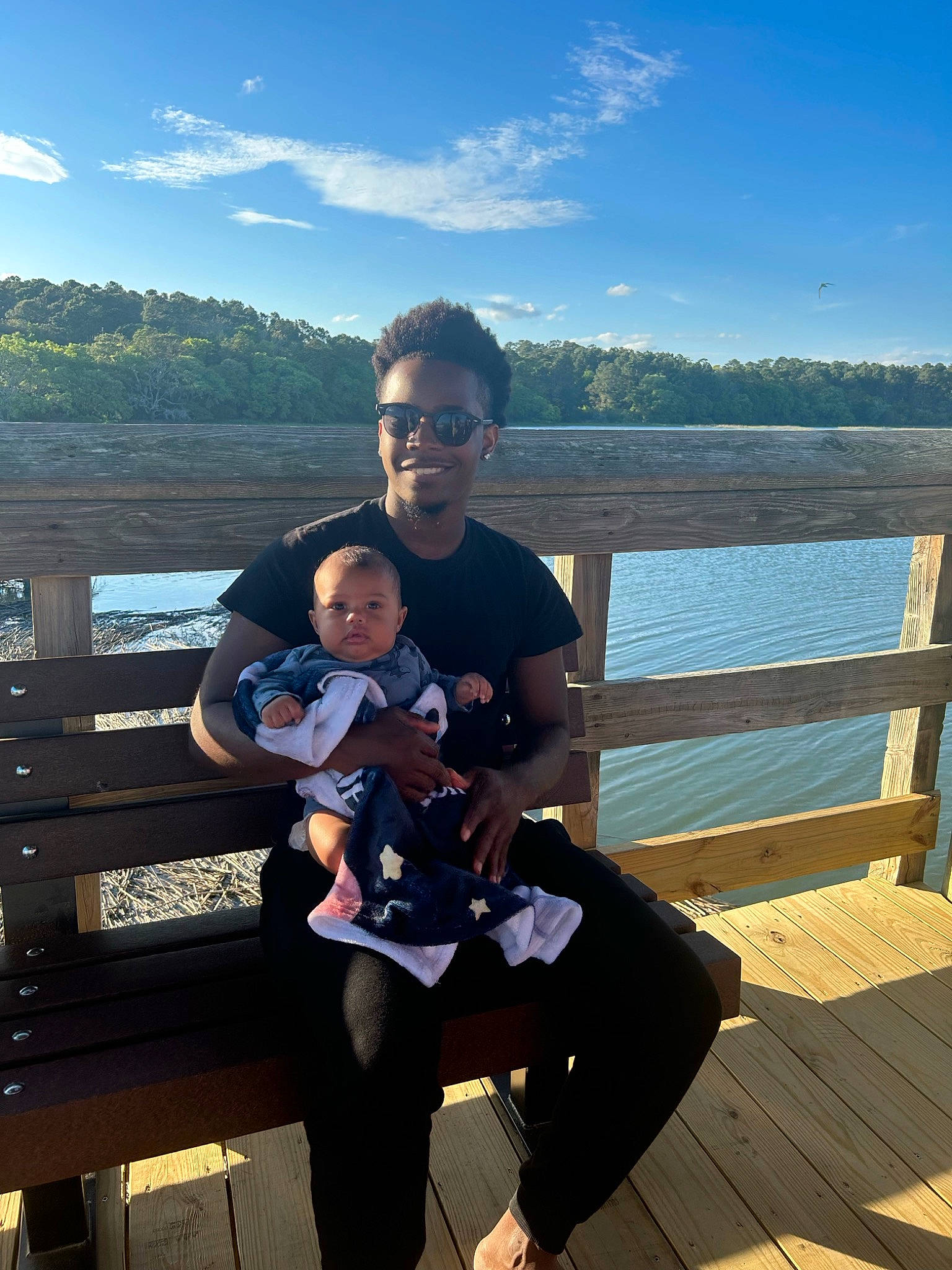 Hakeem joined the competition — help win amazing prizes! baby, cloud, event, eyewear, fence, fun, happy, horizon, joy, lake, landscape, leg, leisure, morning, person, sitting, sky, smile, toddler, tourism