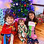 celebration, child, children, christmas_tree, decorations, family, festive, floor, gifts, happy, holiday, indoors, pajamas, presents, siblings, smile, smiling, stockings, toddler, wooden_floor