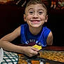 Liam joined the competition — help win amazing prizes! child, boy, smiling, blue_shirt, chip, food, table, indoor, happy, face, portrait, casual, dining, meal, hand, eyes, short_hair, skin, background, mural