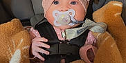 Londyn Serena is registered to the contest to win money with this photo: baby, infant, car_seat, pacifier, blanket, headband, pink, brown, graco, straps, cute, child, toddler, indoors, soft_lighting, portrait, cozy, warm, face, person