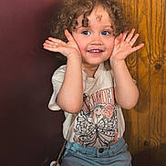 Lydiah joined the competition — help win amazing prizes! booth_seat, bright_eyes, casual_clothing, child, curly_hair, cute, face, hands, happy, indoor, innocent, jeans, playful, portrait, sitting, smiling, toddler, tshirt, wood_paneling, young