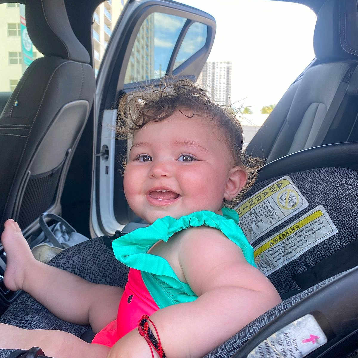 Amelia is registered to the contest to win money with this photo: baby, bodypart, car, city, clothing, cushion, face, finger, hand, happy, head, homedecor, person, photography, portrait, smile, t_shirt, transportation, urban, vehicle