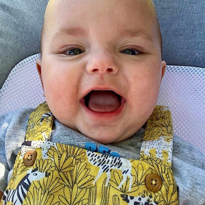 Tobias joined the competition — help win amazing prizes! animal_print, baby, button, child, clothing, cushion, cute, eyes, face, grass, happy, head, infant, mouth_open, outdoor, person, portrait, skin, smiling, yellow_overall