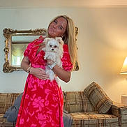 Moses joined the competition — help win amazing prizes! blonde_hair, bracelet, carpet, casual, couch, cozy, dog, dress, floral_pattern, furniture, home, indoor, lamp, living_room, mirror, pet, portrait, smiling, watch, woman
