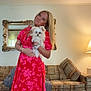 blonde_hair, bracelet, carpet, casual, couch, cozy, dog, dress, floral_pattern, furniture, home, indoor, lamp, living_room, mirror, pet, portrait, smiling, watch, woman