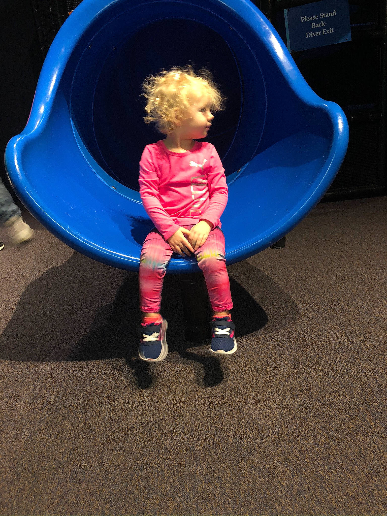 Rosella is registered to the contest to win money with this photo: baby, blue, child, chute, cobalt_blue, electric_blue, human_settlement, leisure, majorelle_blue, organ, outdoor_play_equipment, person, play, playground, playground_slide, public_space, purple, sitting, space, toddler