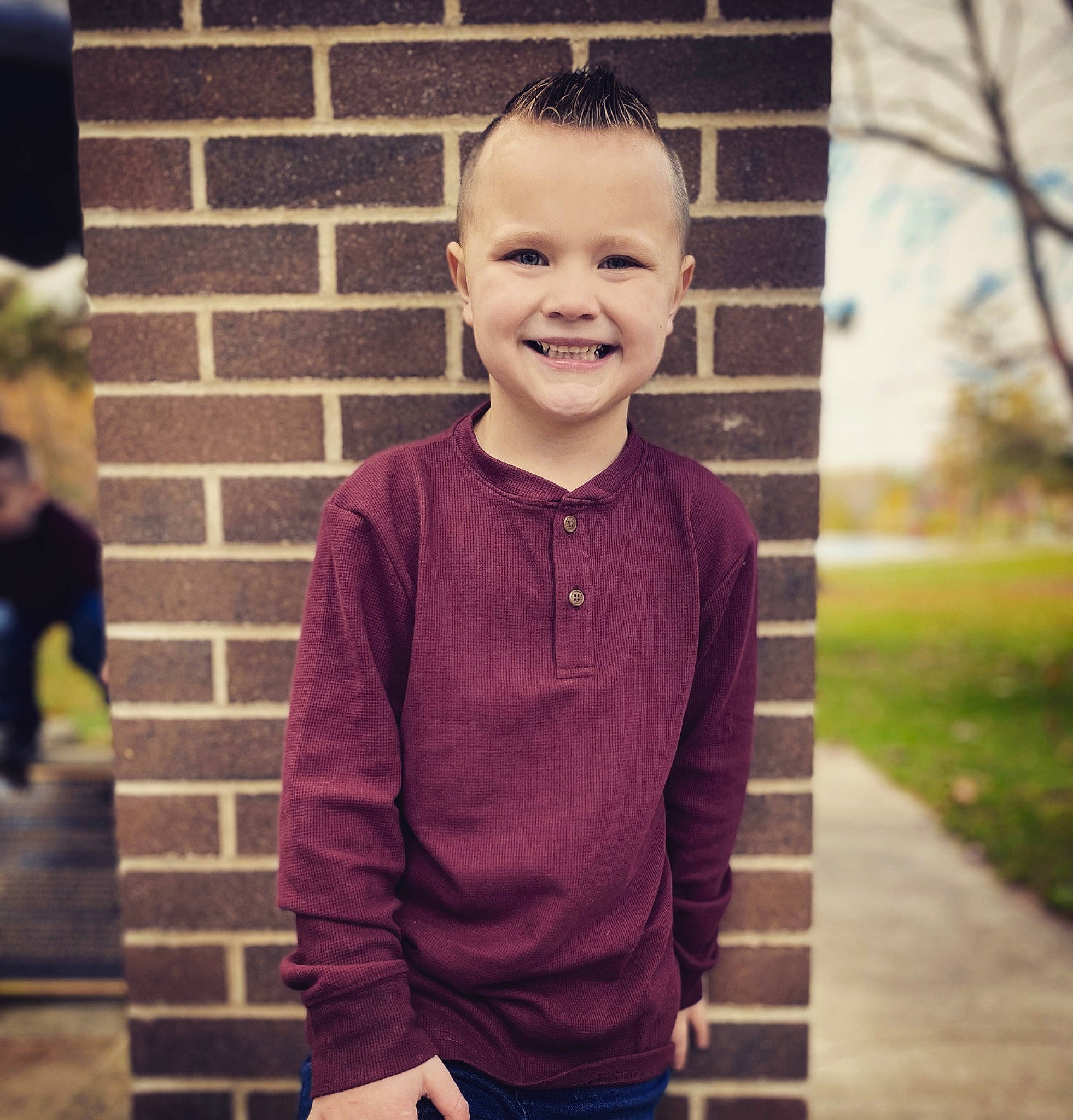 Bentley is registered to the contest to win money with this photo: beauty, child, chin, cool, dress_shirt, eyewear, fun, happy, joy, neck, person, plant, shoulder, sleeve, smile, sportswear, standing, street_fashion, t_shirt, tree