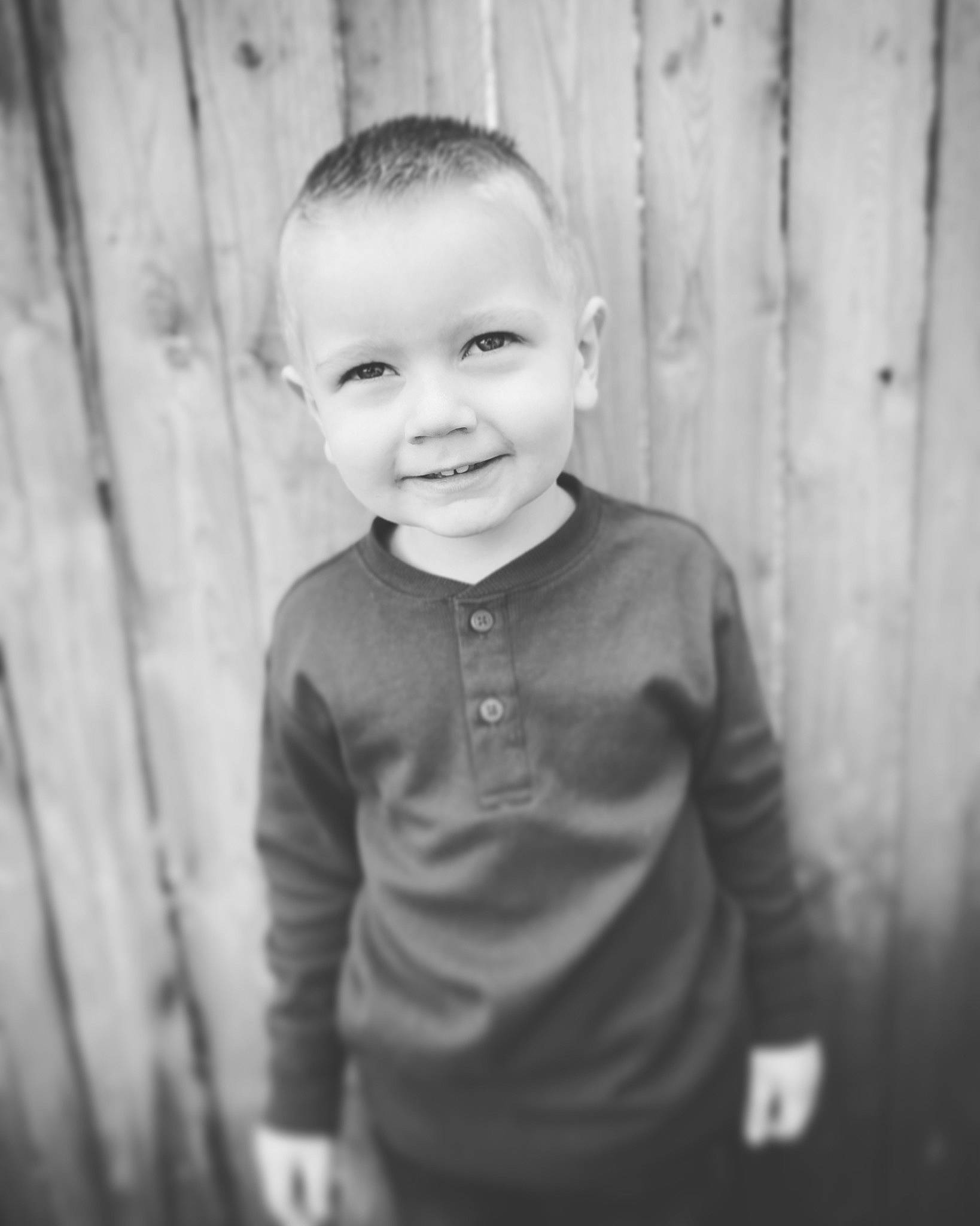 Greyson is registered to the contest to win money with this photo: black_and_white, cheek, chin, eye, flash_photography, fun, grey, happy, human_body, iris, joy, monochrome, monochrome_photography, person, skin, sleeve, smile, standing, style, t_shirt