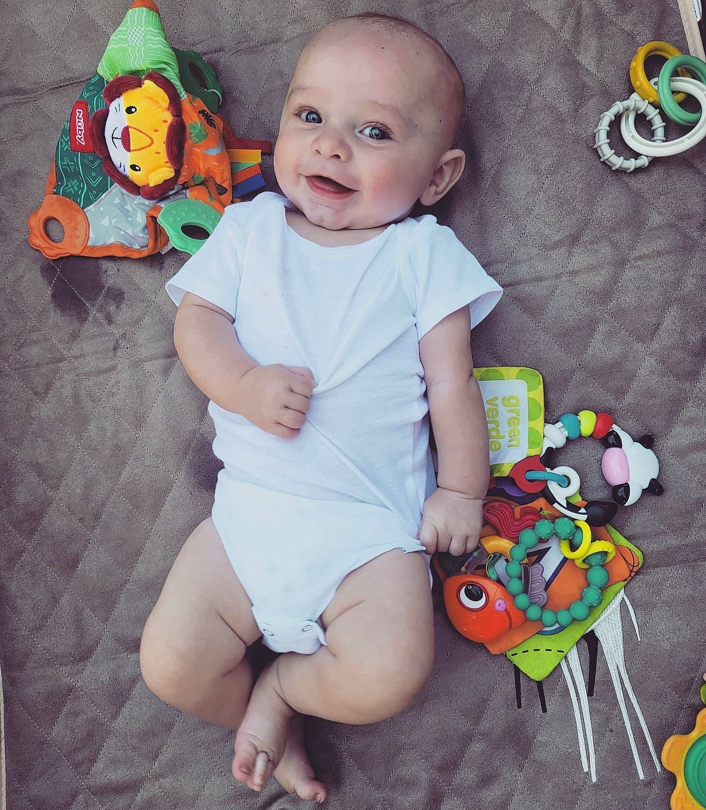 Hudsyn is registered to the contest to win money with this photo: baby, baby_toddler_clothing, cheek, green, happy, head, leg, orange, organ, people, person, photograph, pink, product, shorts, skin, sleeve, smile, t_shirt, textile