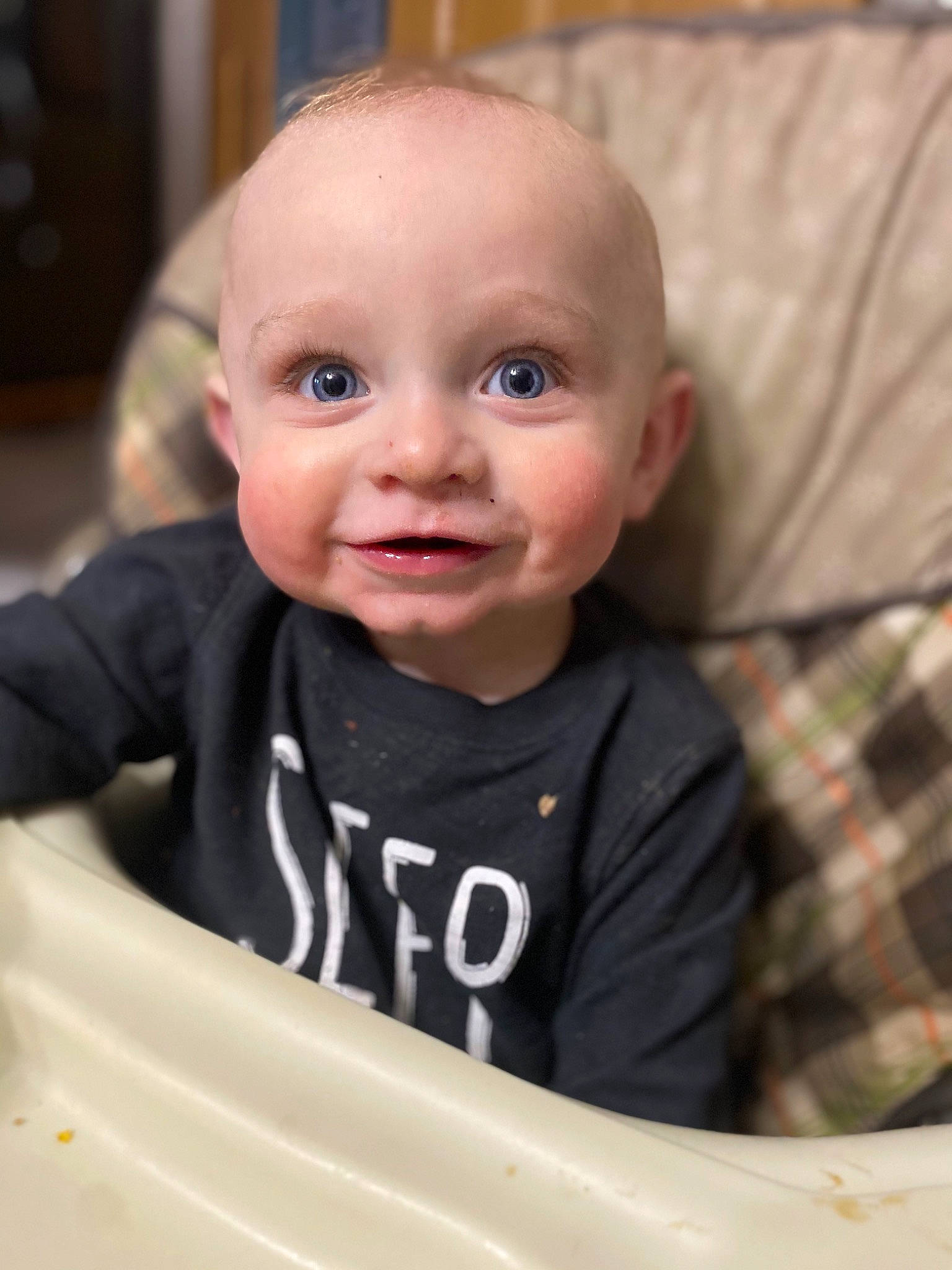 Hudsyn is registered to the contest to win money with this photo: baby, baby_toddler_clothing, cheek, chin, eye, eyebrow, facial_expression, fun, hairstyle, happy, iris, mouth, nose, outerwear, person, product, skin, sleeve, smile, t_shirt