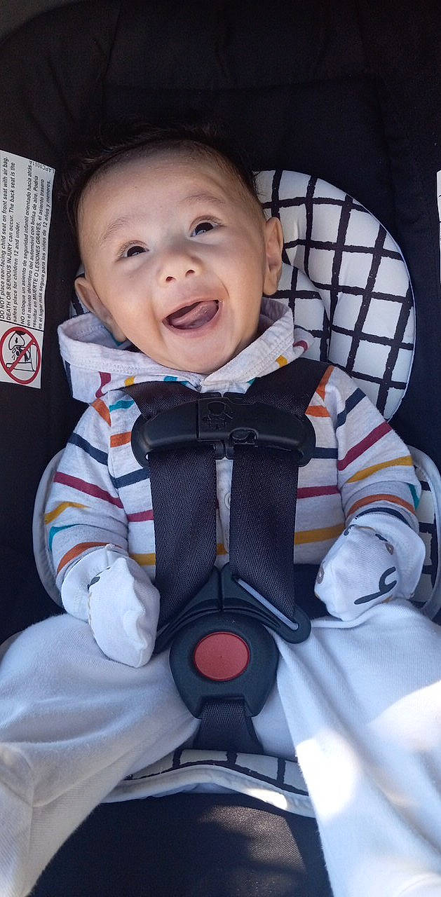 Alexander is registered to the contest to win money with this photo: baby, baby_products, baby_toddler_clothing, carmine, cheek, child, collar, comfort, electric_blue, finger, fun, happy, laugh, outerwear, person, personal_protective_equipment, sitting, sleeve, smile, thumb