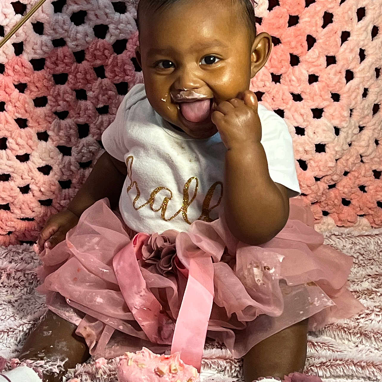 Layelle is registered to the contest to win money with this photo: baby, blanket, celebration, child, clothing, crocheted_backdrop, cupcake, cute, flower, footwear, frosting, girl, happy, headband, pink, portrait, sitting, smiling, tongue_out, tutu
