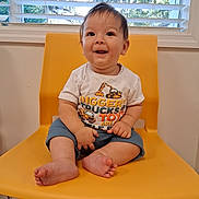 Samuel joined the competition — help win amazing prizes! baby, child, smiling, yellow_chair, indoor, window, blinds, shorts, tshirt, barefoot, happy, cute, person, sitting, infant, home, face, portrait, young, furniture