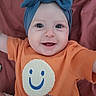 Delaney joined the competition — help win amazing prizes! apparel, baby, bow, child, cute, eyes, face, hand, happy, headband, indoors, infant, mouth, orange_shirt, person, portrait, skin, smiley_face, smiling, textile