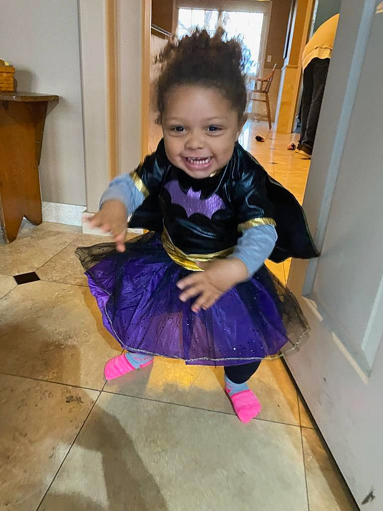 Izara is registered to the contest to win money with this photo: baby_toddler_clothing, child, door, dress, electric_blue, floor, flooring, formal_wear, fun, happy, hardwood, joy, magenta, person, pink, purple, sitting, sleeve, smile, sock