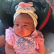 Veniza Snow is registered to the contest to win money with this photo: baby, infant, pink_clothing, headband, bow, car_interior, steering_wheel, cute, portrait, person, hand, soft_lighting, stitch_and_angel, clothing, sitting, child, human, closeup, newborn, cute_expression