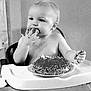 Layken joined the competition — help win amazing prizes! appetite, baby, black_and_white, cake, child, cute, eating, face, fingers, food, hand, high_chair, indoor, messy, mouth, person, plate, sprinkles, table, young_child
