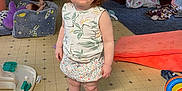 Kairi joined the competition — help win amazing prizes! baby, blanket, blue_eyes, carpet, child, clutter, curious, floor, floral_skirt, furniture, indoors, living_room, person, red_hair, sandals, standing, toddler, topknot, toys, vent