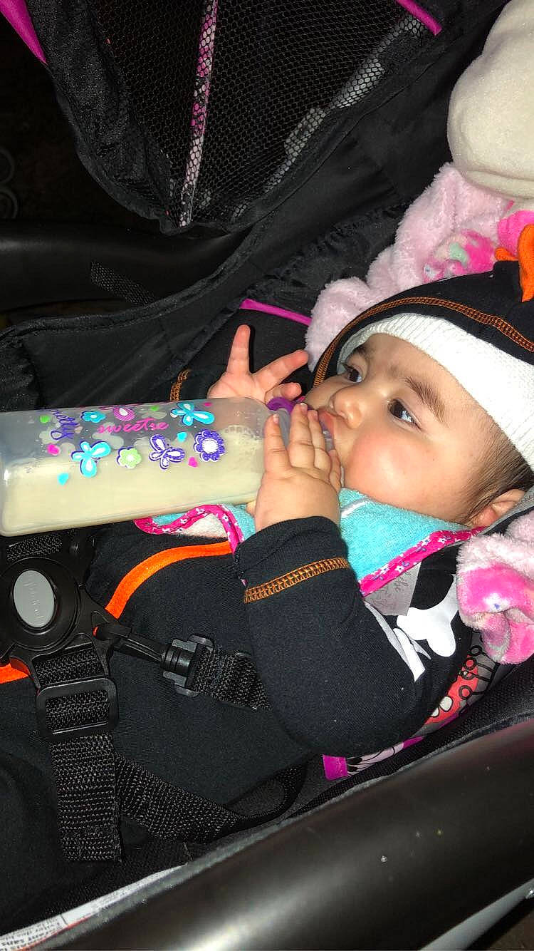 Leeyana is registered to the contest to win money with this photo: auto_part, automotive_design, baby, baby_carriage, baby_products, car_seat, child, comfort, costume_hat, event, eyelash, fashion_accessory, fun, headwear, magenta, mouth, person, pink, purple, steering_wheel