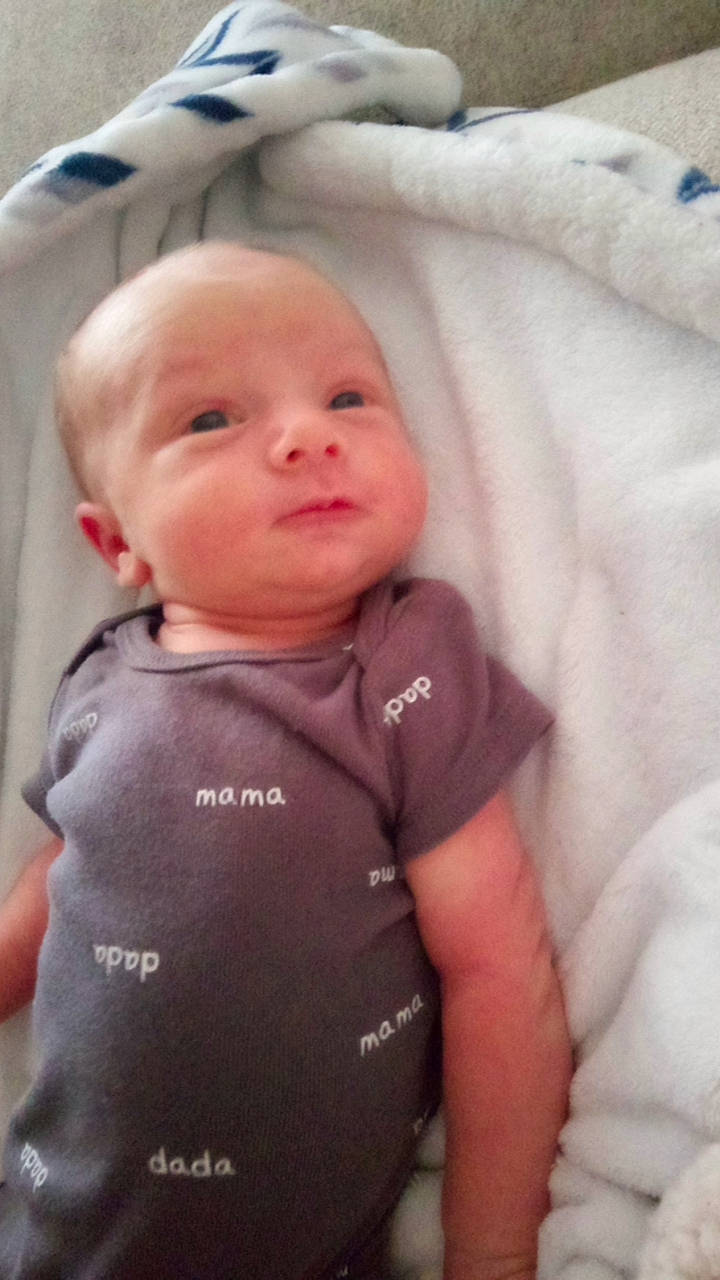 Zander is registered to the contest to win money with this photo: baby, baby_products, baby_toddler_clothing, cheek, child, comfort, eyebrow, eyelash, happy, nose, person, personal_protective_equipment, sitting, sleeve, smile, t_shirt, toddler