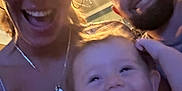Sonny is registered to the contest to win money with this photo: baby, adult, family, smile, indoor, people, happy, portrait, blurry, low_light, casual, laughing, woman, man, child, candid, head, face, necklace, hair