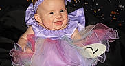 Charlea joined the competition — help win amazing prizes! baby, bonnet, clothing, costume, dress, face, footwear, formalwear, happy, hat, head, laughing, newborn, person, photography, portrait, purple, shoe, sitting, toy