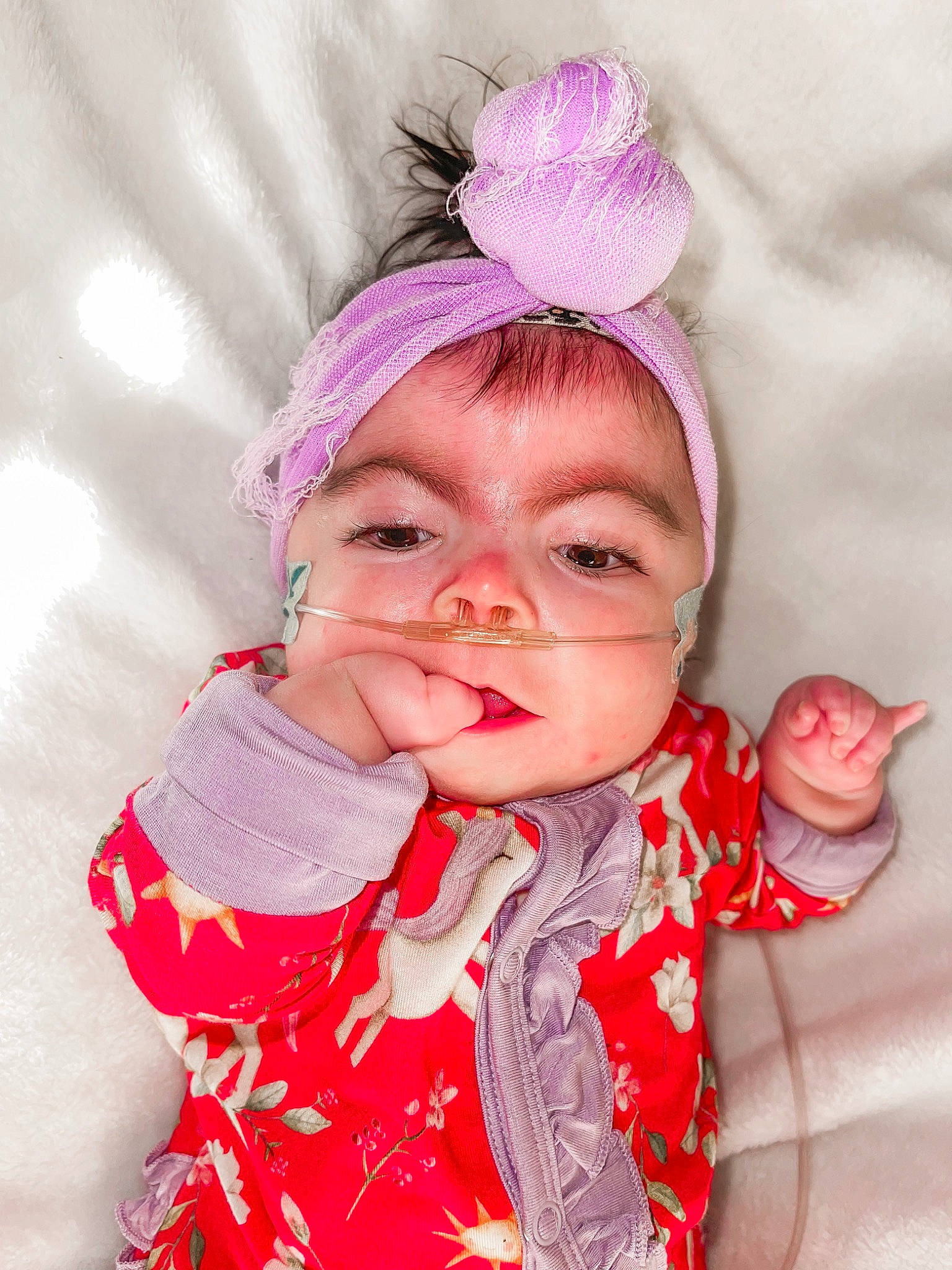 Atlee is registered to the contest to win money with this photo: baby, baby_toddler_clothing, beanie, cap, cheek, chin, eyelash, fashion_accessory, gesture, happy, headpiece, headwear, knit_cap, lip, magenta, pattern, peach, person, pink, sleeve