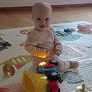 Jeanette is registered to the contest to win money with this photo: architecture, baby, bodypart, clothing, couch, cutlery, face, finger, furniture, hand, head, hosiery, person, photography, portrait, sitting, sock, spoon, table, text